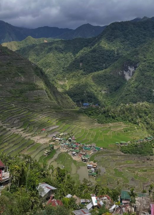 Batad village and its tin roofs ringed by terrace walls under heavy Cordillera cloud